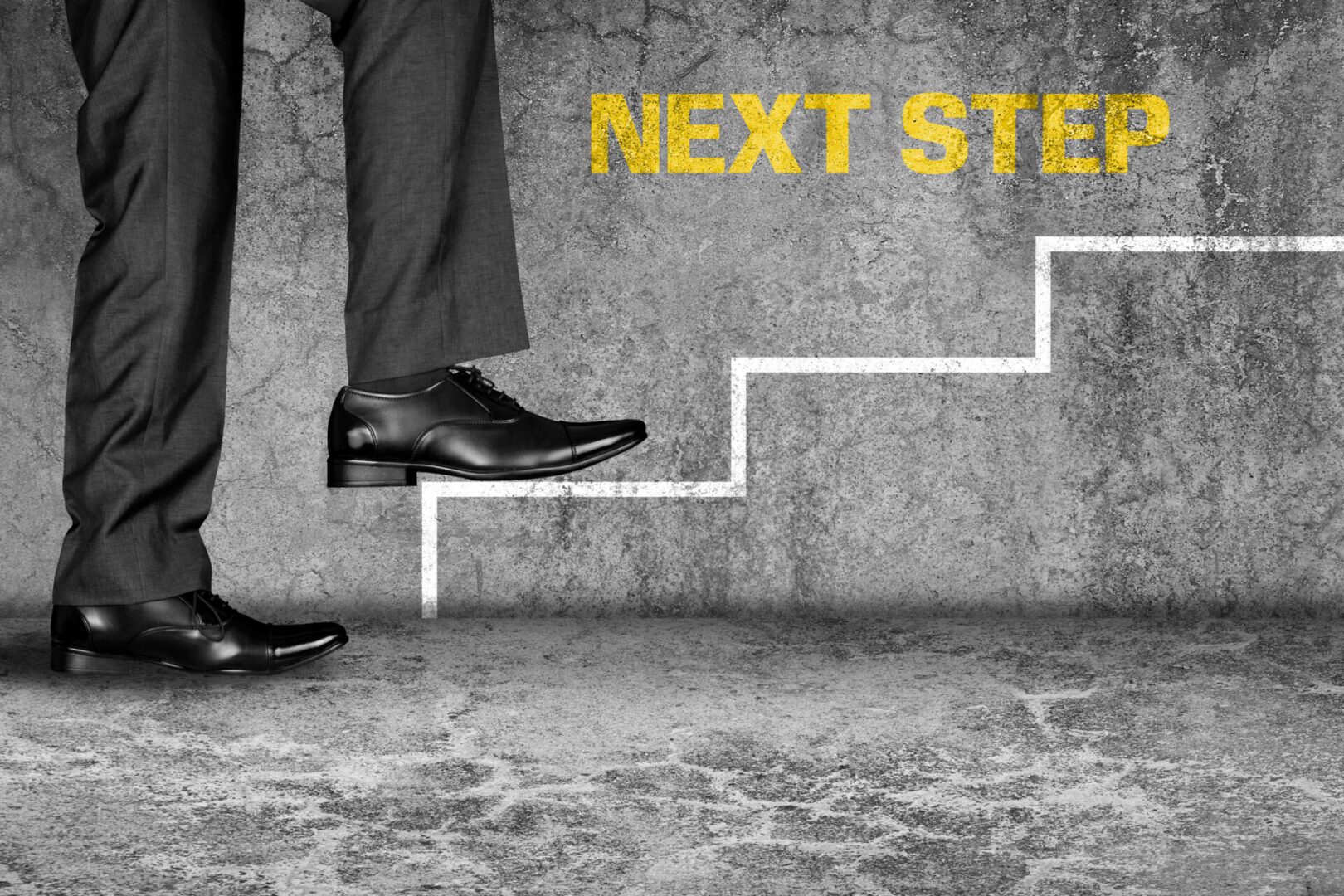 Low section view of a businessman climbing on stairs representing the concept of successful business.